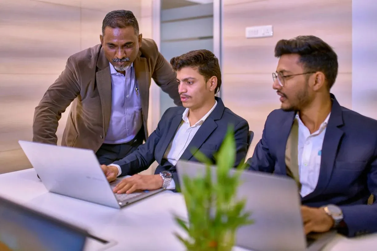 A lecturer interacting with two students.